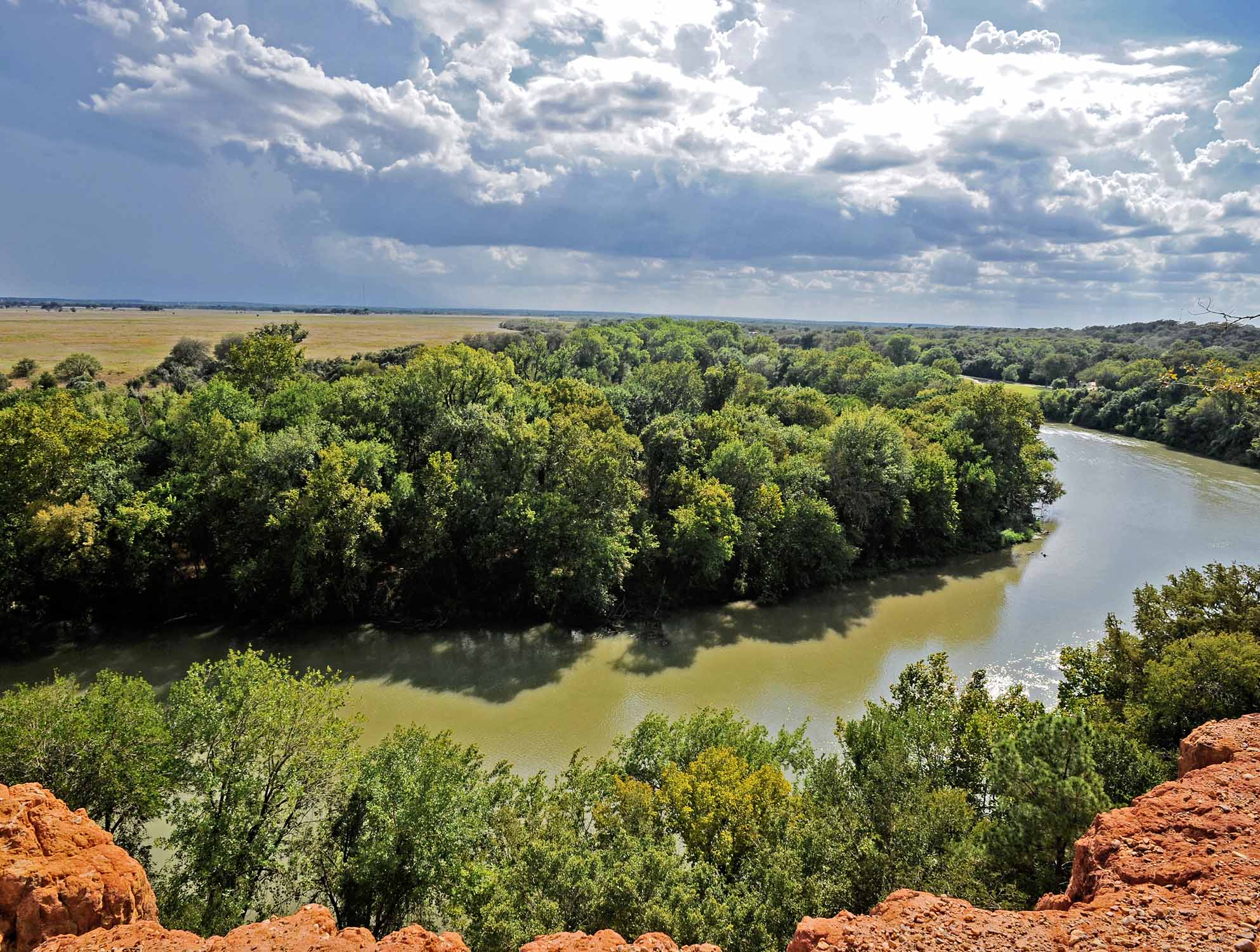 Winding river and green countryside viewed from a rocky overlook