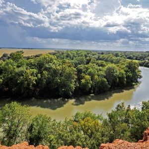 Winding river and green countryside viewed from a rocky overlook