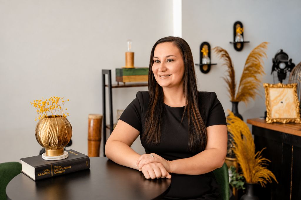 Bre Meador, REALTOR® with All City Real Estate, seated at a table
